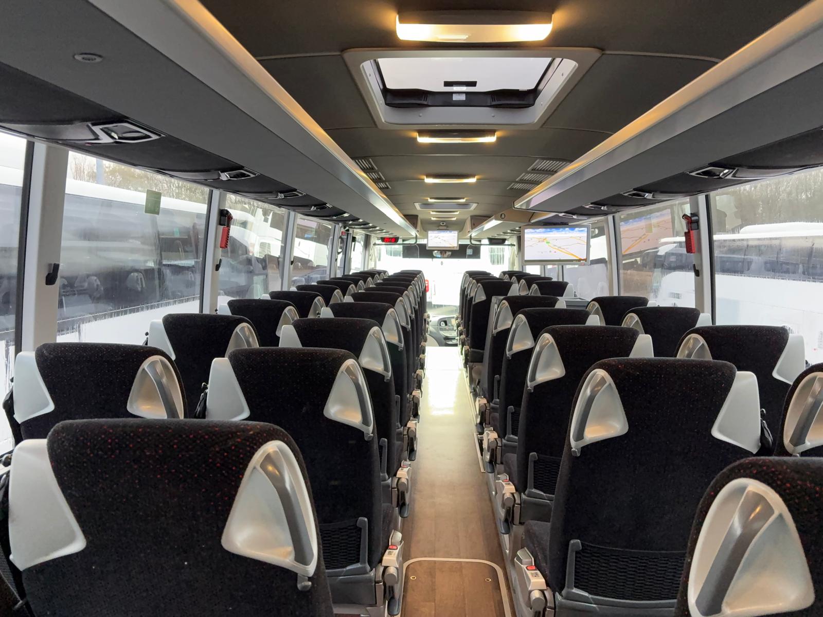 Modern coach interior with safety features and comfortable seating