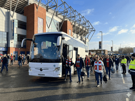 Coach arriving at a sports stadium on match day